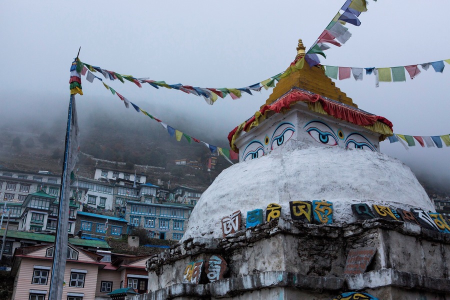 A chhorten in Namche Bazaar with angular view of Namche.