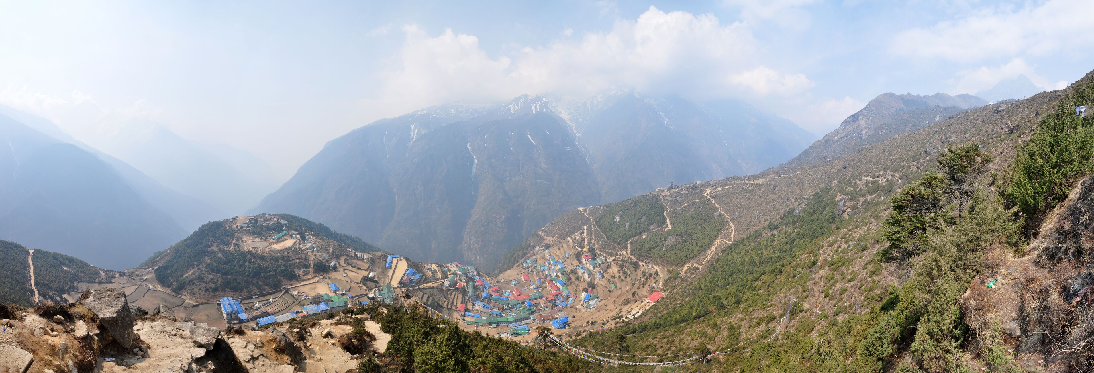 A mountainous landscape with a village nestled in a valley.