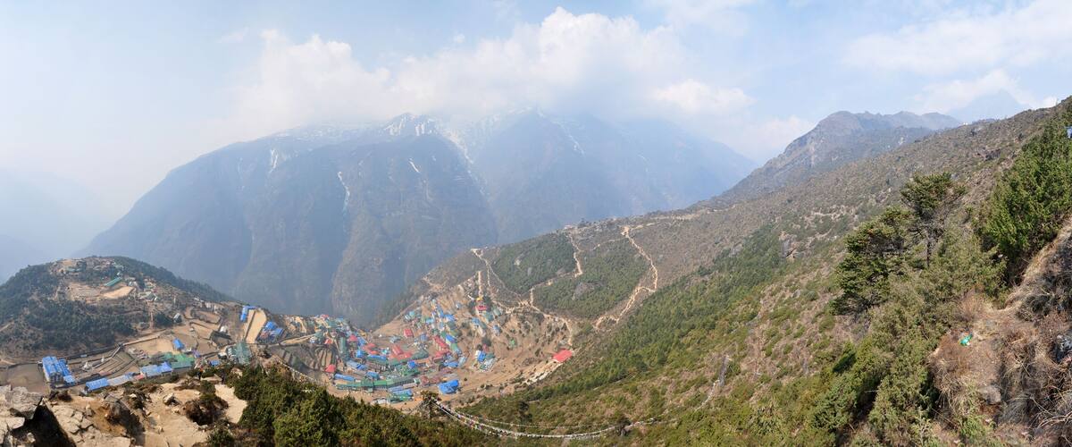 A mountainous landscape with a village nestled in a valley.