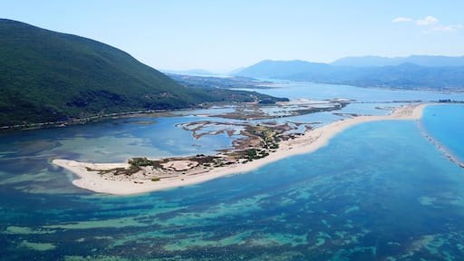 Aerial drone bird's eye view photo of tropical and exotic coral reef forming an atoll archipelago with beautiful sapphire and turquoise open ocean