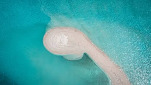 Aerial drone view of a sandbank in a blue lagoon, Vashafaru, Haa Alif Atoll, Maldives.
