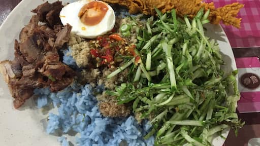 If you are a tourist or just feeling like wanting to try something unique go for this salad rice (Nasi Kerabu). Mix all the ingredients well preferably with hands. Eating with your hand is the norm here. Steal a glance and see how the locals did it.