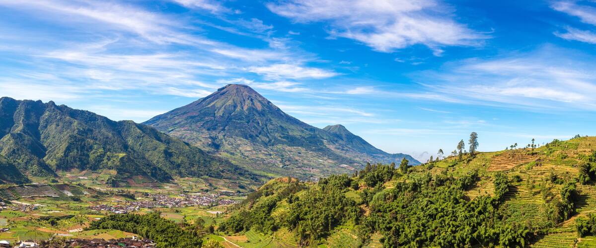 A mountainous landscape with terraced fields and a village.