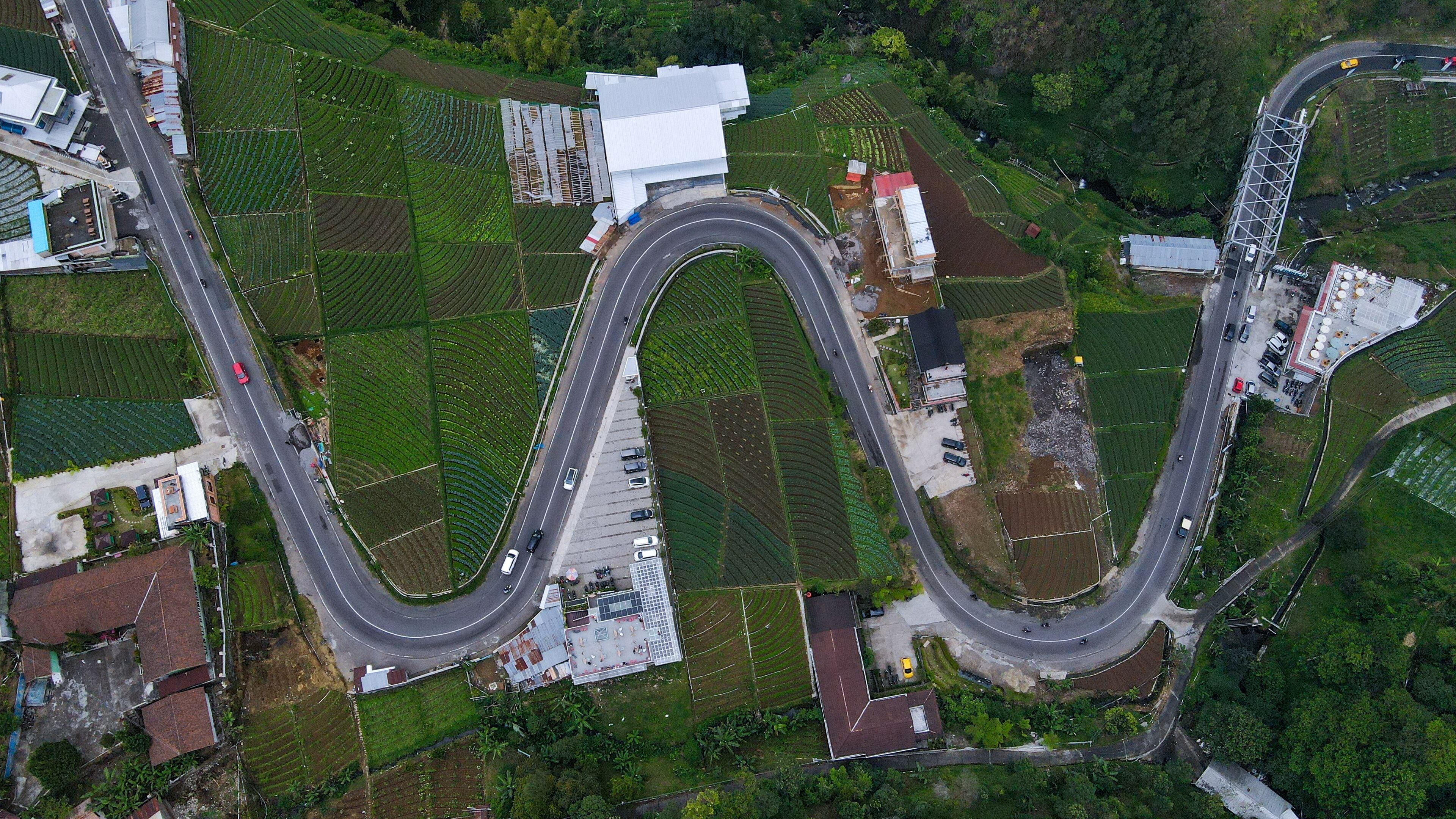 Aerial view, winding road in Tawangmangu on the edge there are plantation fields