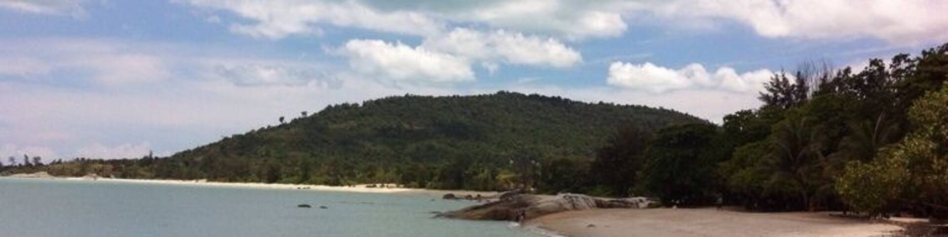 Tanjung Pesona beach on a sunny day. You can walk to the middle of the sea.