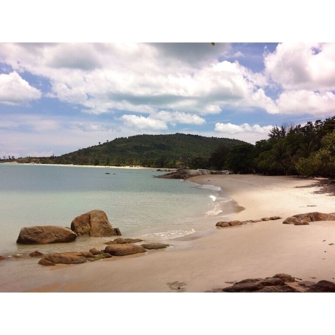 Tanjung Pesona beach on a sunny day. You can walk to the middle of the sea.
