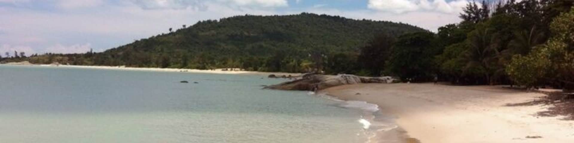 Tanjung Pesona beach on a sunny day. You can walk to the middle of the sea.