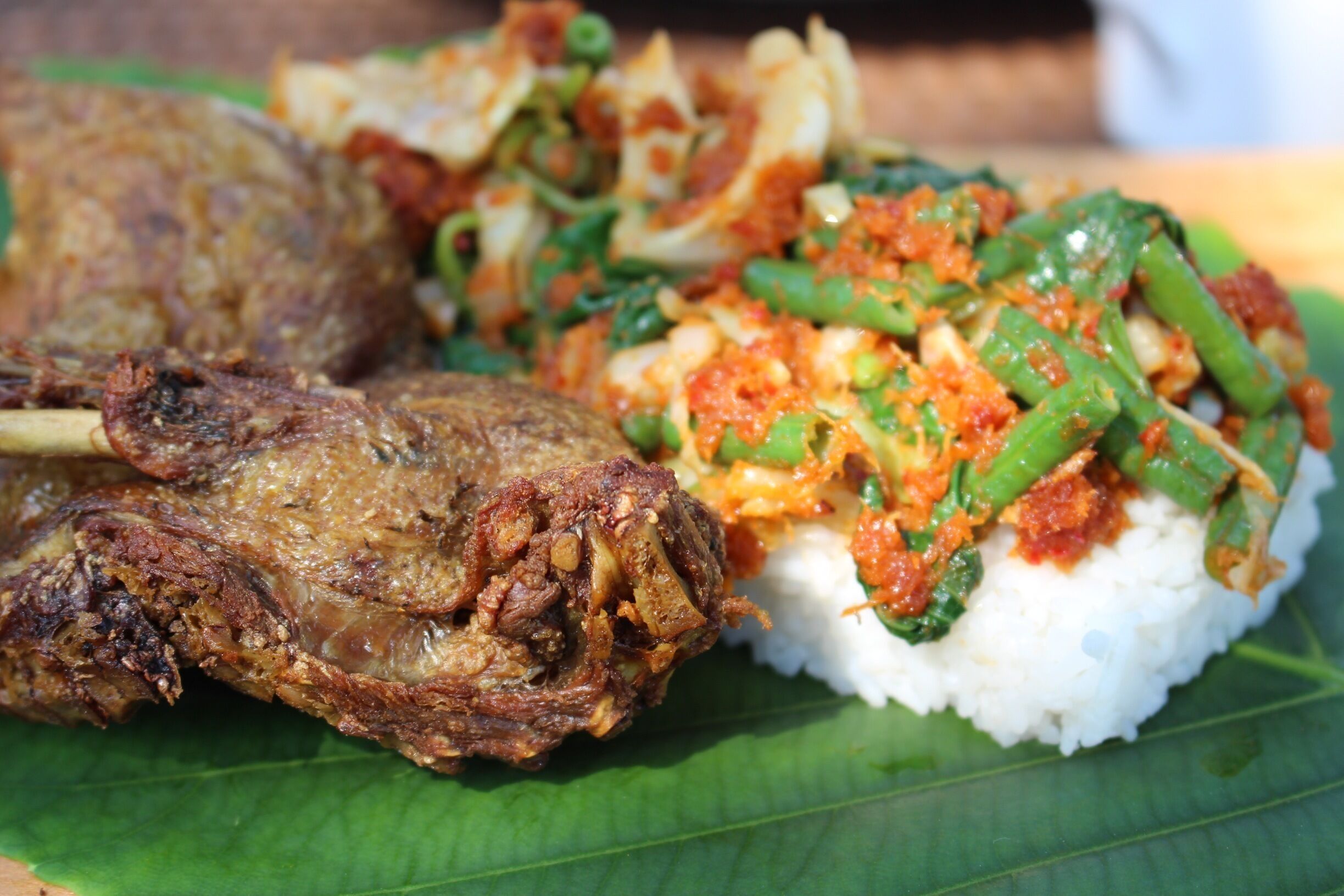 Inside "Bird in a cage" dish, fried duck, vegetables with coconut spices and rice. 
