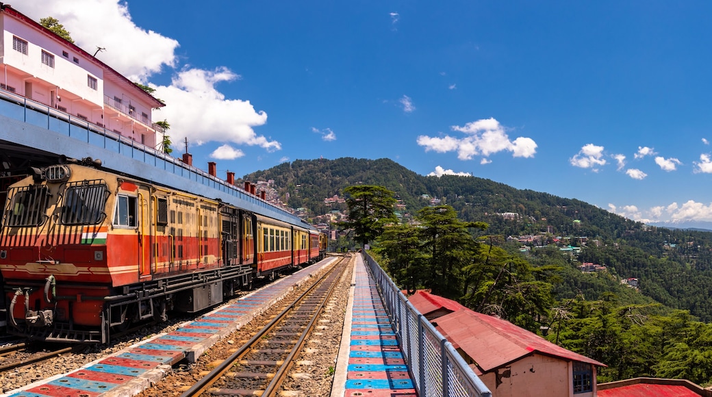 Toy train Kalka-Shimla route, standing on Shimla railway station with city in background. Shimla is state capital & tourist holiday destintation in the hill state Himachal Pradesh, India.