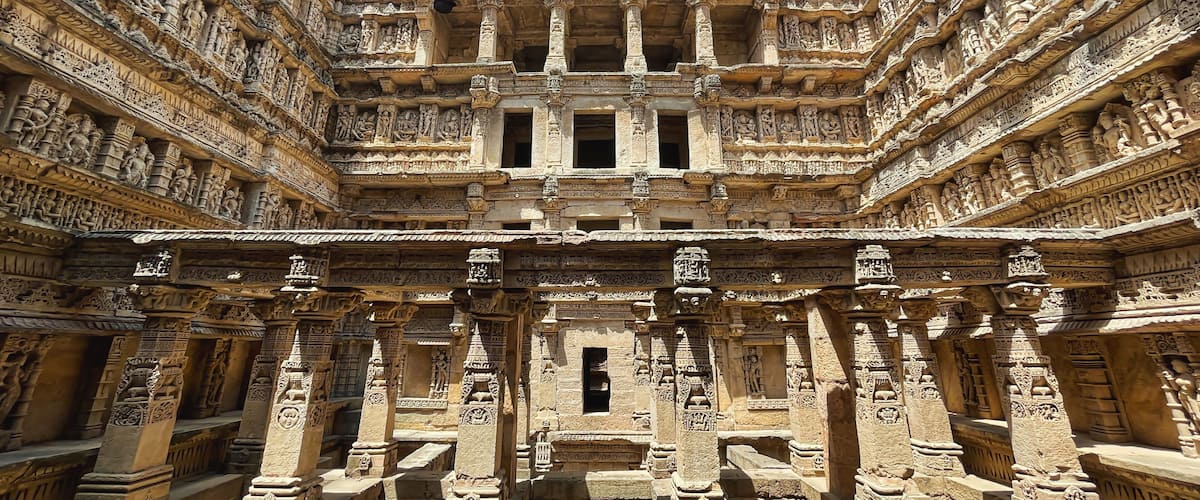 An intricately carved stone temple with multiple levels of detailed sculptures and columns.