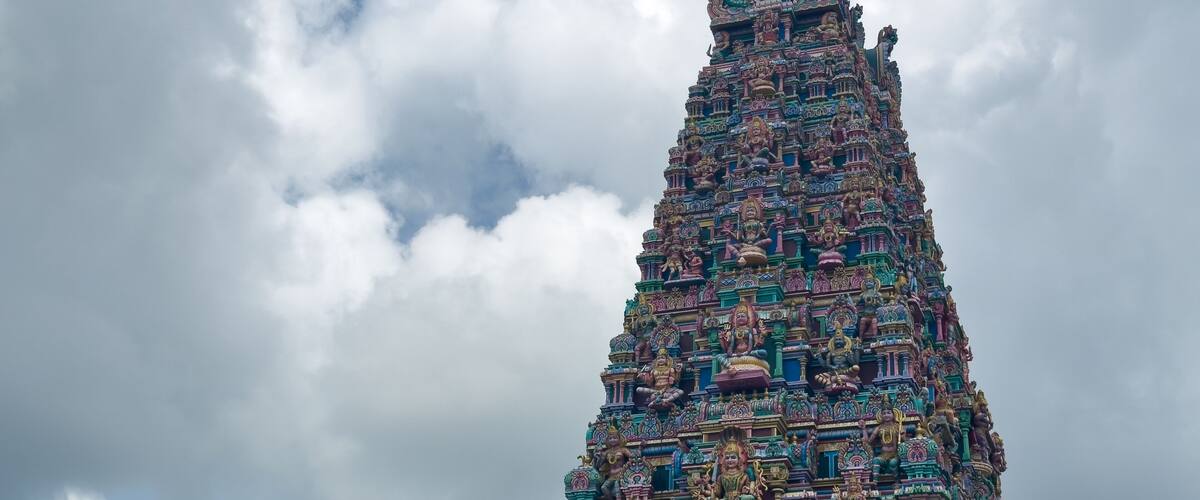 A multi-tiered temple with intricate carvings and statues.