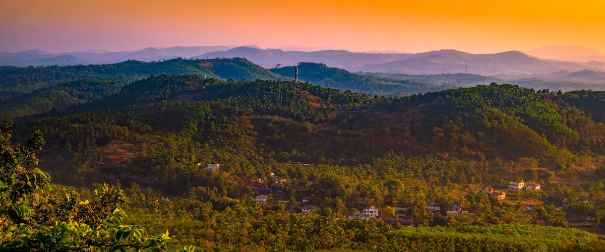 A mountainous landscape with a sunset.