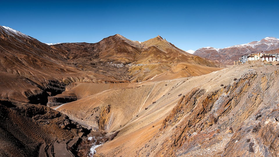 A mountainous landscape with a village nestled in the valley.