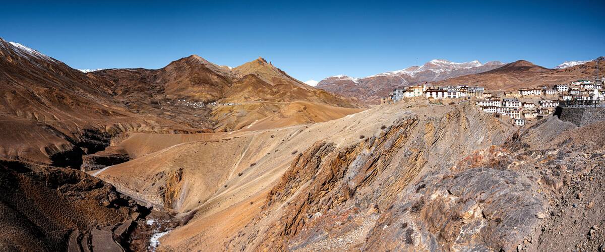 A mountainous landscape with a village nestled in the valley.