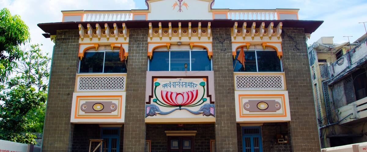 A building with a colorful facade, large windows, and a central emblem.