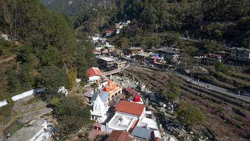NAINITAL, UTTARAKHAND, INDIA - MARCH 15, 2024 : Aerial drone view of the famous Kainchi Dham Temple (Neem Karoli Baba Ashram) situated in the Kumaon hills.