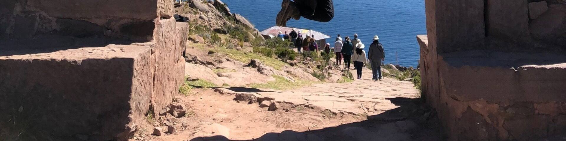 A stone archway with a person jumping through it.