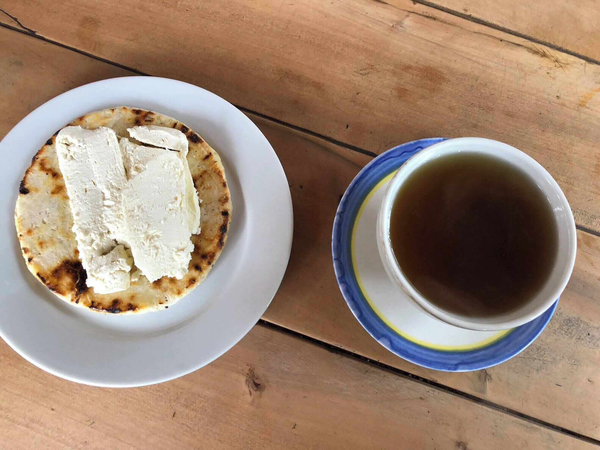Tasty breakfast in Guarne, Colombia ... arepa and aguapanela (sugar cane drink)