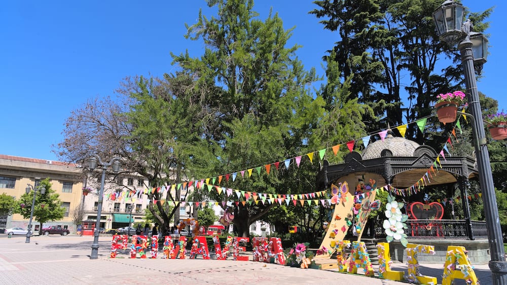 View of letters "Primavera Talca" (="spring Talca" in spanish) at the entrance of Plaza de Armas park in a small south american town (Talca, Chile)
