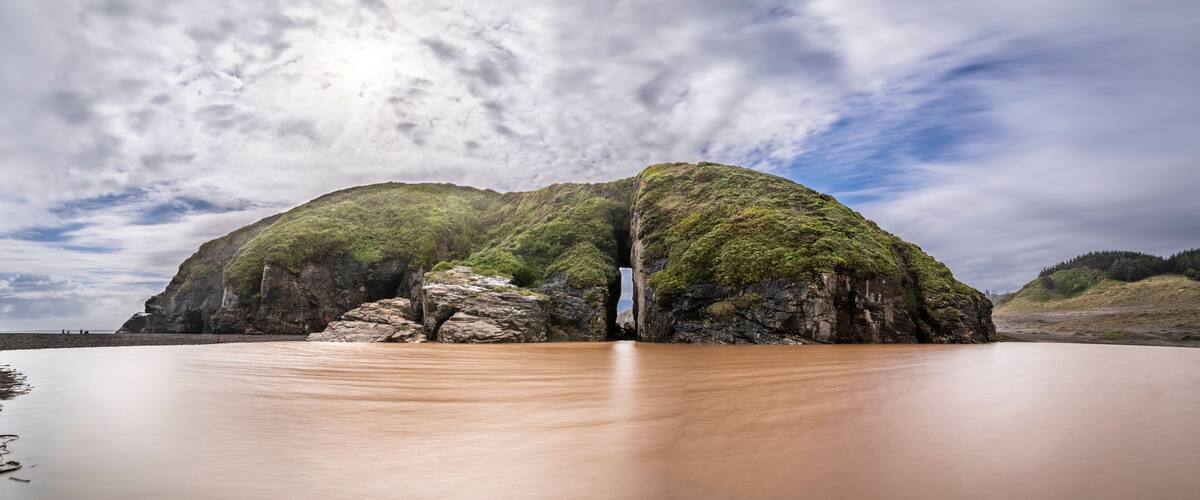 A river flowing through a rocky landscape with a waterfall.