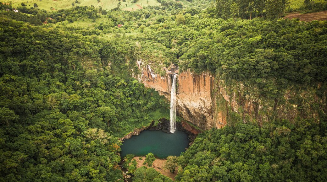 Aerial View Of Tall Waterfall And Lake Surrounded By Lush Green Forest In Rolante, Rio Grande Do Sul, Brazil.
