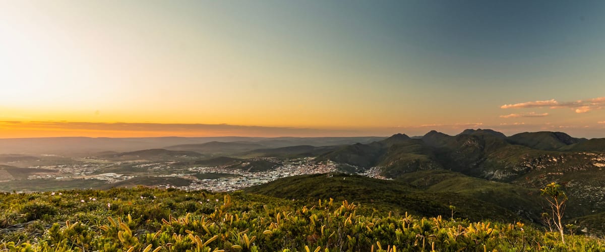 A mountainous landscape with a town in the valley below.