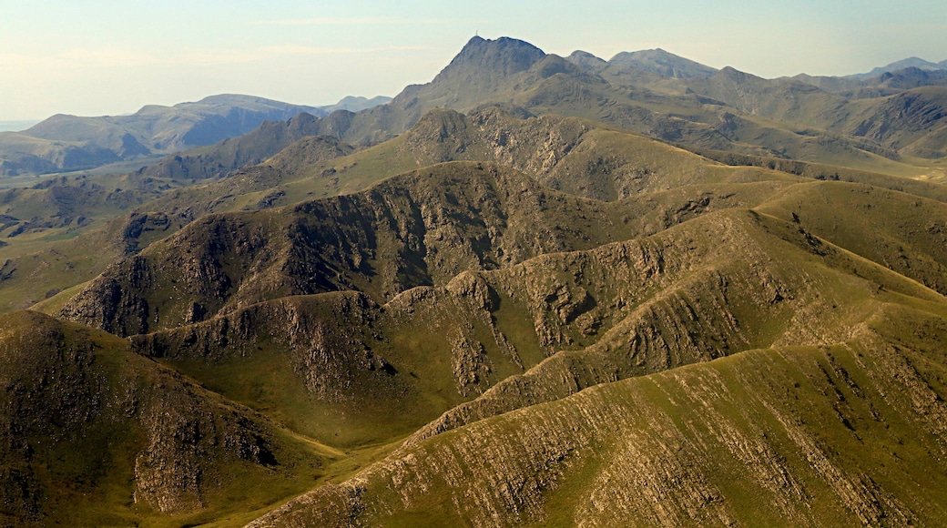 A rugged mountainous landscape with a prominent peak in the center.