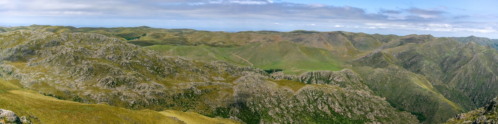 A mountainous landscape with rolling hills and a clear sky.