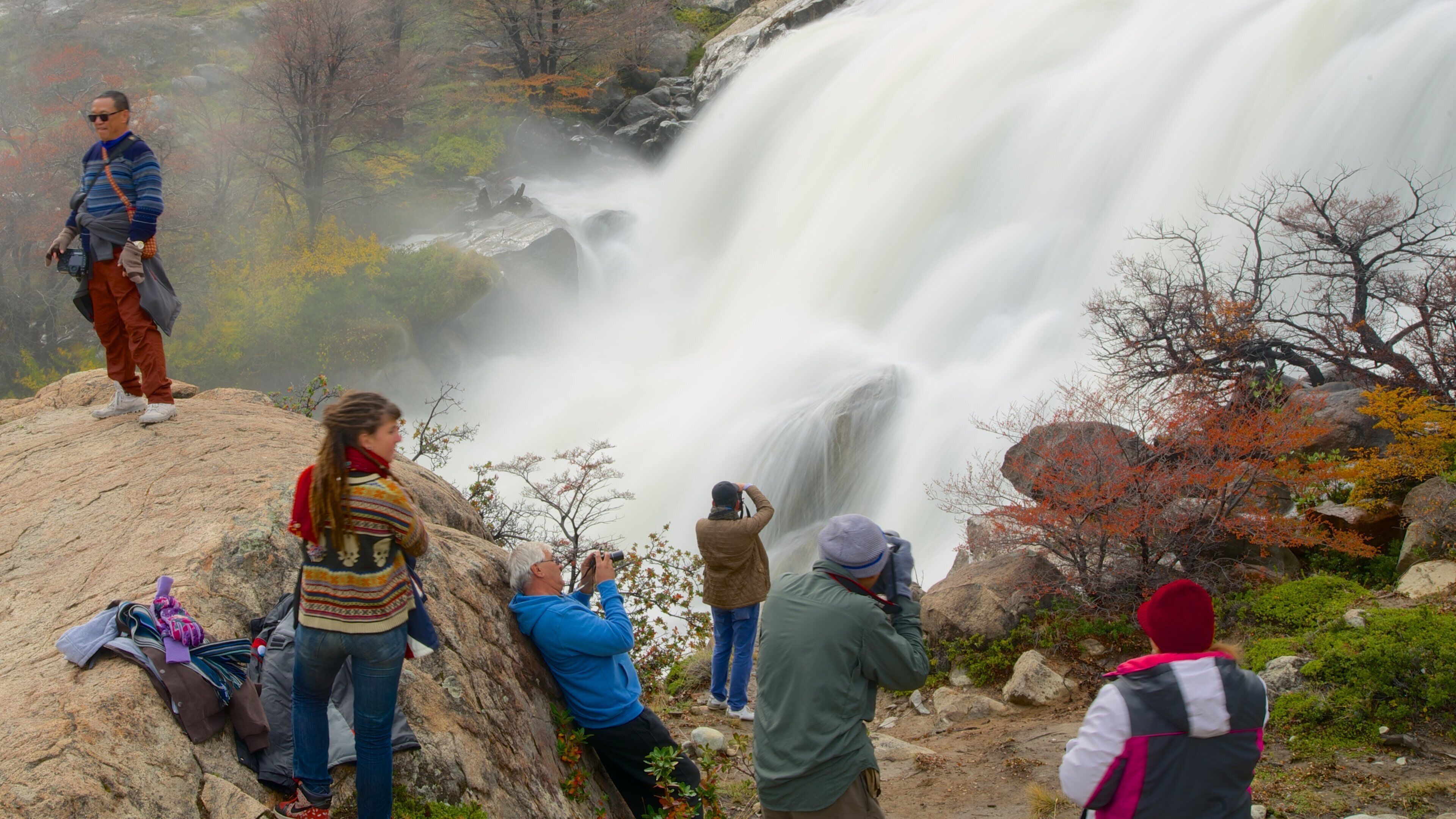 El Calafate featuring a waterfall as well as a small group of people