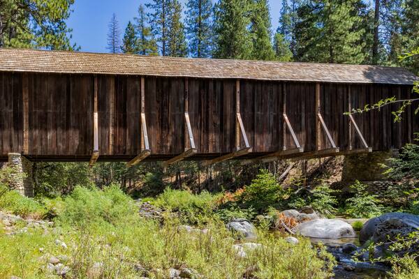 View of Yosemite Wawona covered Bridge over the South Fork Merced River in Mariposa, during the summer, California, USA