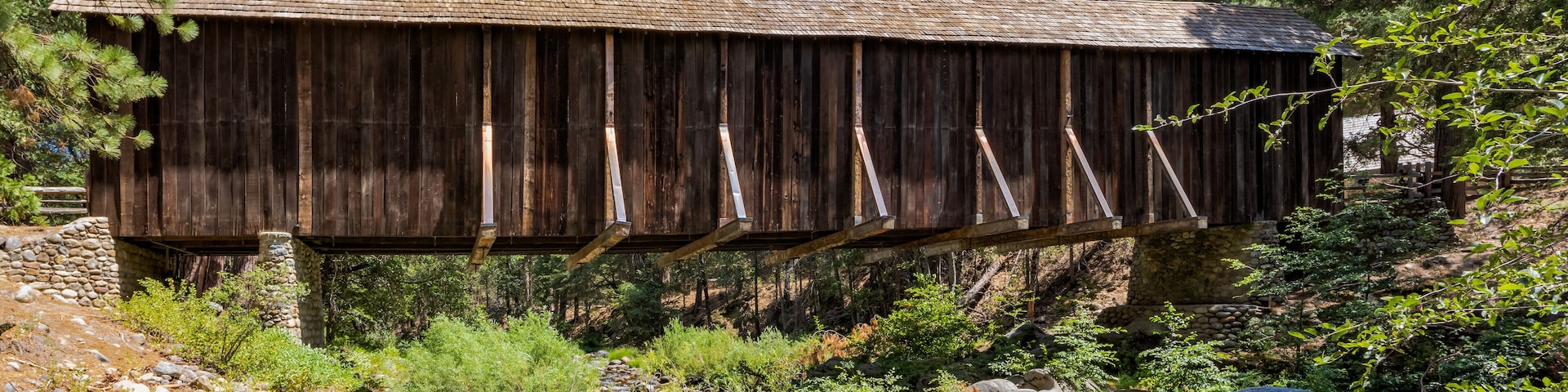 View of Yosemite Wawona covered Bridge over the South Fork Merced River in Mariposa, during the summer, California, USA