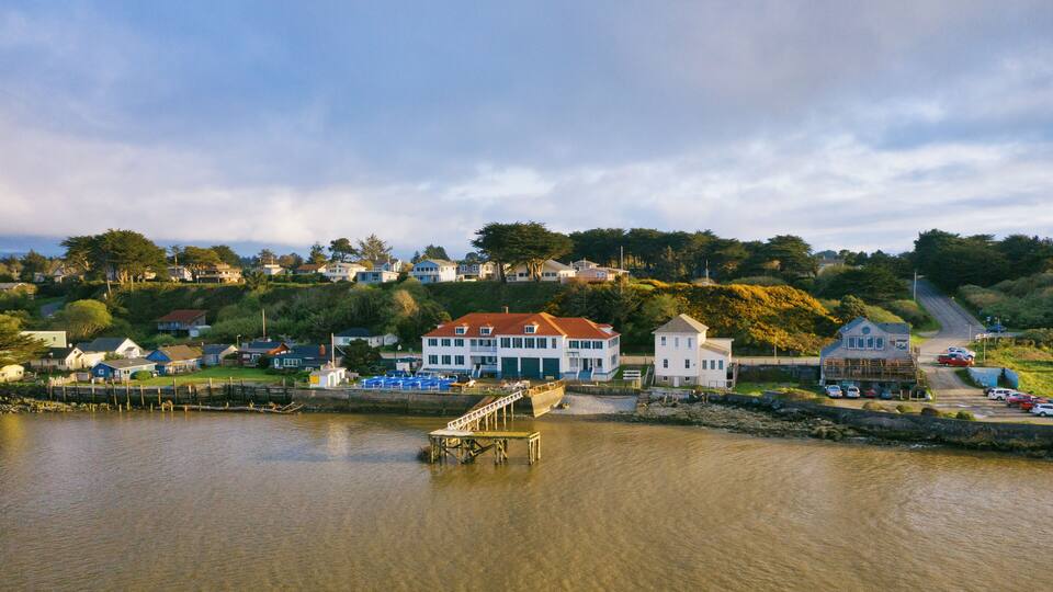 A coastal town with houses, a bridge, and a dock.