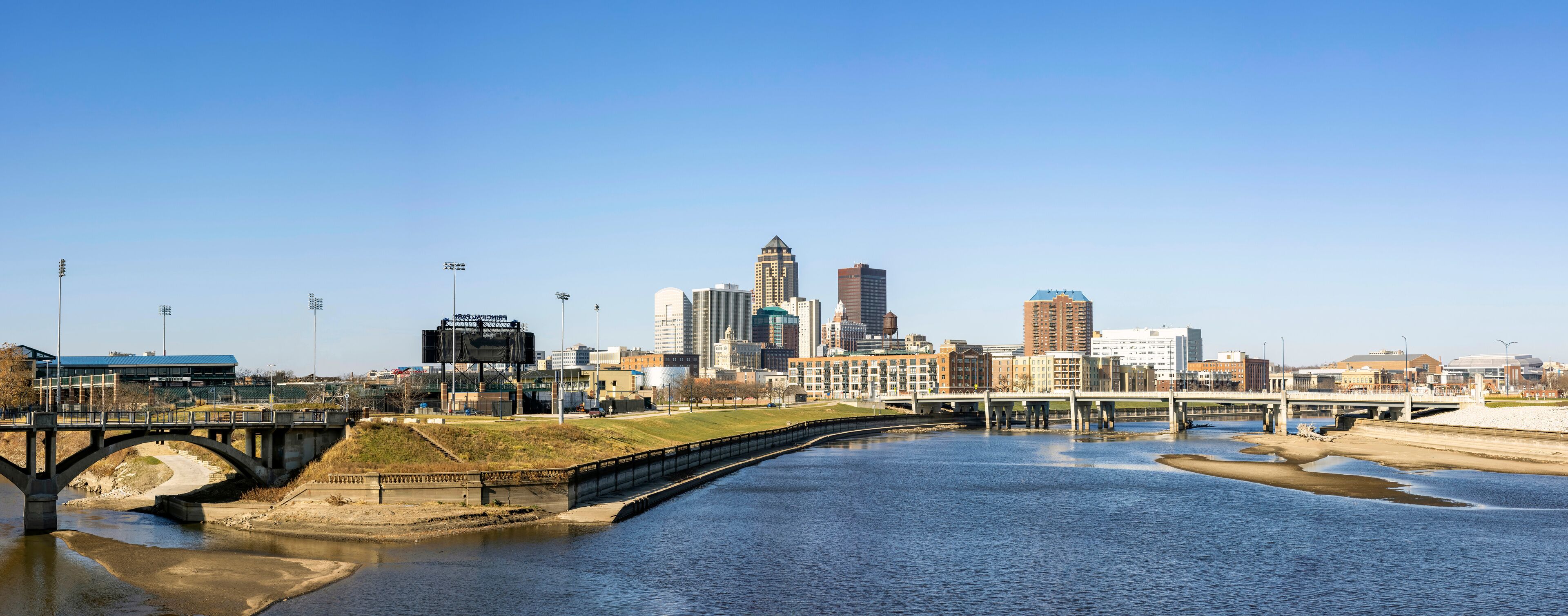 Panorama of Downtown Des Moines with bridges over the confluence of the Des Moines and Raccoon Rivers at daytime.