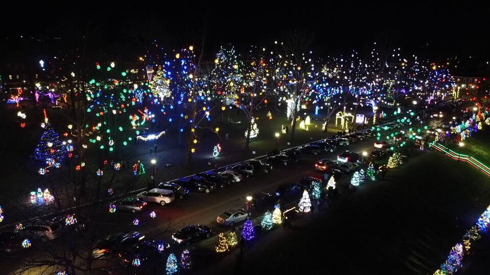 A nighttime view of a city with numerous Christmas lights and decorations.
