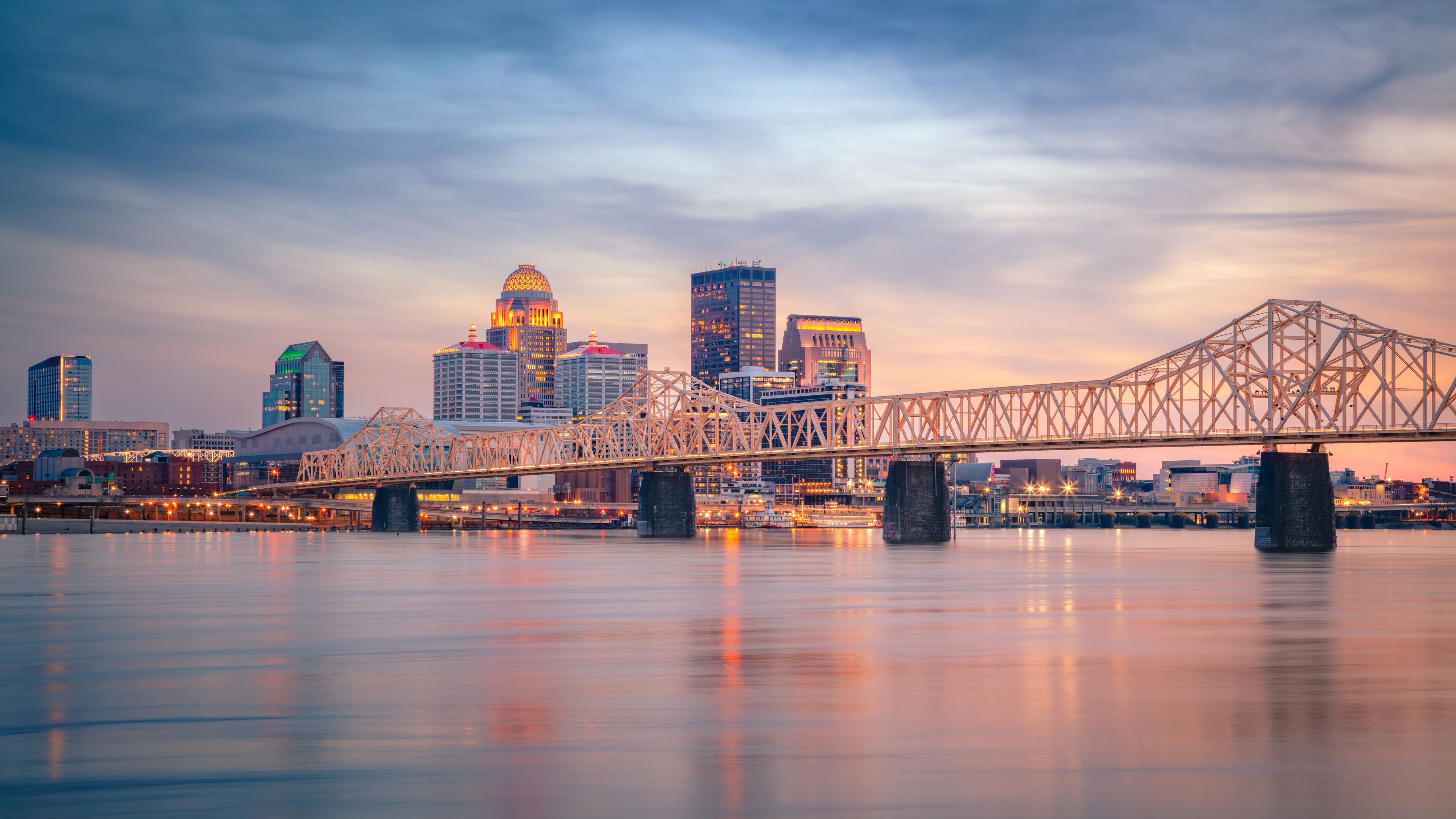 Louisville, Kentucky, USA. Cityscape image of Louisville, Kentucky, USA downtown skyline with reflection of the city the Ohio River at spring sunset.