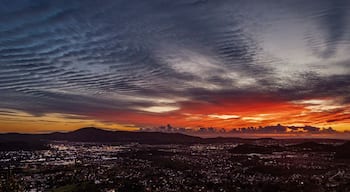 A beautiful sunset from a hill overlooking a city with storm clouds. The view is from Escondido Ca looking west toward San Marcos,Carlsbad and Oceanside Ca