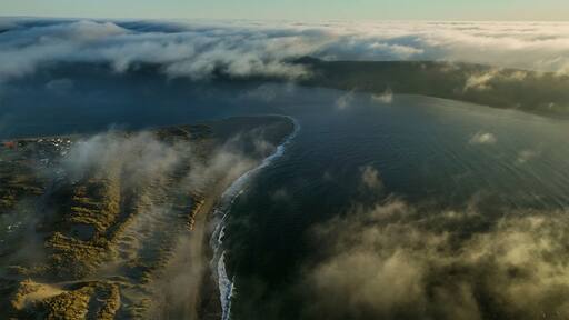 Aerial view of the tranquil coastline with waves and fog, Point Reyes, Dillon Beach, California, United States.