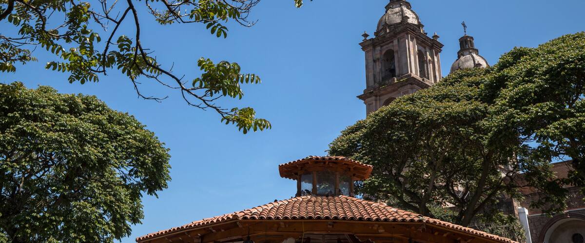 A church with a bell tower and a tiled roof.