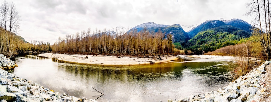 Iron Oxide Stained rocks lining the shore at low water in the Squamish River in the Upper Squamish Valley in British Columbia, Canada