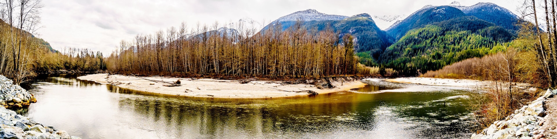 Iron Oxide Stained rocks lining the shore at low water in the Squamish River in the Upper Squamish Valley in British Columbia, Canada