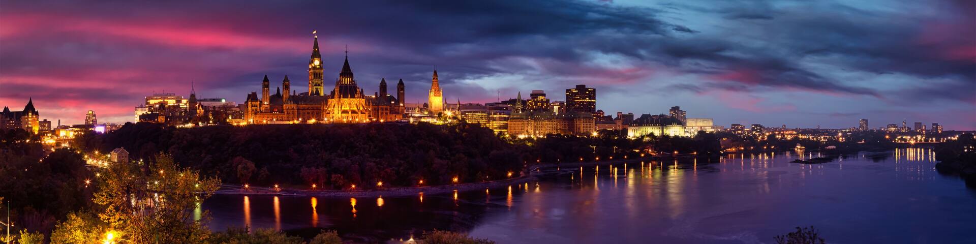 Panoramic view of Downtown Ottawa and the Parliament of Canada. Taken from Nepean Point, Ontario, Canada. Colorful Dramatic Sunset Artistic Render