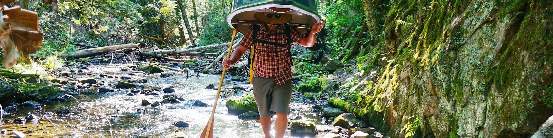 K carrying our canoe down a difficult portage near Mt St Marie, Quebec during our 3 day canoe camping trip. He's a rock star, that canoe is not light!