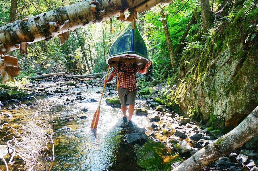 K carrying our canoe down a difficult portage near Mt St Marie, Quebec during our 3 day canoe camping trip. He's a rock star, that canoe is not light!