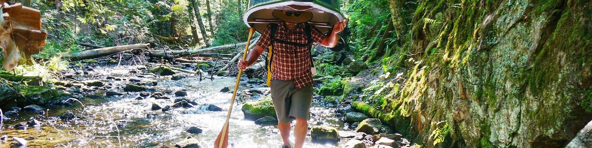 K carrying our canoe down a difficult portage near Mt St Marie, Quebec during our 3 day canoe camping trip. He's a rock star, that canoe is not light!