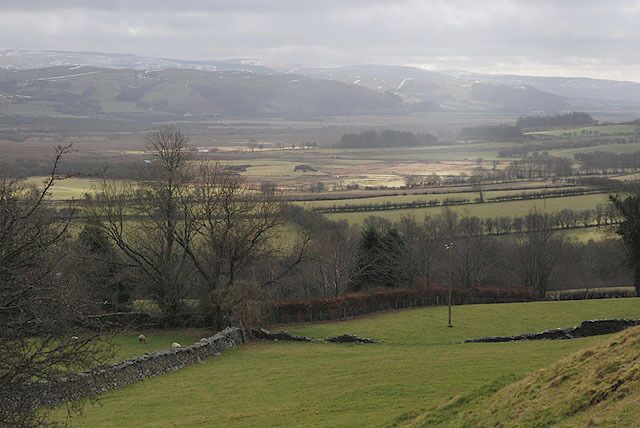 View towards Cors Caron from near Pen-y-graig-isaf farm Looking over good grazing land east of Ystrad Meurig to the vast flat expanses of the bog, with the Cambrian Mountains beyond.