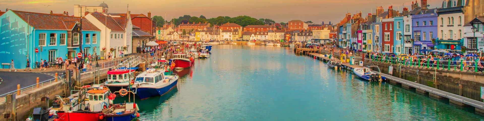 A harbor with colorful buildings and boats docked along the water.