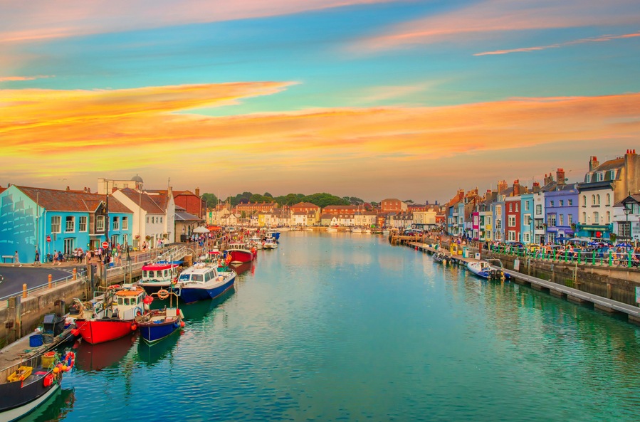 A harbor with colorful buildings and boats docked along the water.