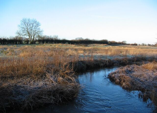 Early morning sun on the River Weaver The Weaver is little more than a stream as it passes through flat pastureland outside the village of Wrenbury. View on a frosty January morning, just west of the bridge on New Lane. A nearby view can be seen in 190703