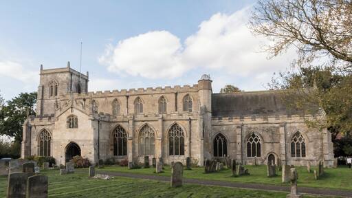 Wrangle is mentioned in the Domesday Book of 1086 when it was spelt Weranghe but by 15th century it had been changed to Wranghill. There was almost certainly a Saxon church on the site in 1086 and the present church is based on the beautiful cathedrals of 12th century France. It is a Marshland church, ie predominantly perpendicular, but there are older parts as well. The arch on the east side of the tower and the south door are believed to be 1190s. The church was given with much land to Waltham Abbey, Essex in the time of Henry II (1154-89) – the priests of that period being supplied by Waltham Abbey. In the glass of the east window was once an inscription “Thomas de Wyversty, abbas de Waltham me fieri fecit” (the dates of his abbacy of Waltham are 1345-71) The church was rebuilt in the 1400s. St Mary & St Nicholas is built in late Norman and Early English style with later additions. It has a fine pulpit of the Elizabethan period and a tower with six bells. Wrangle was an important place in the 13th and 14th centuries when the church was built. In 1359 King Edward III needed a navy to invade France and Wrangle was asked to help. It sent one ship and eight men (Liverpool only sent five men). Although now a mile from the sea, in medieval times Wrangle Church sat next to a creek up which boats sailed from the Wash. The river has long since been silted up but the outline of the banks can still be seen in a field next to the church.