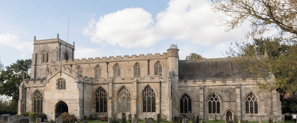A historic church with a large tower and arched windows.